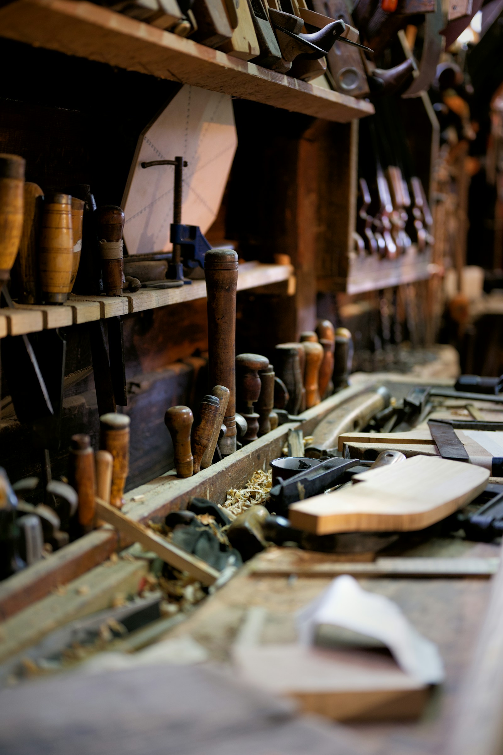 Hand tools and a tape measure on a wooden workbench